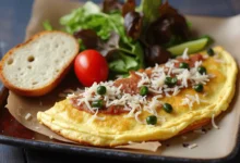 A Greek omelette served with a side of fresh greens and vegetables.