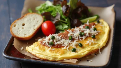 A Greek omelette served with a side of fresh greens and vegetables.